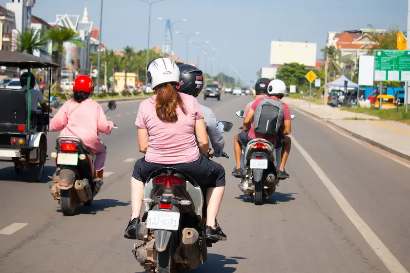 Bike tour riders on a rural Cambodian road
